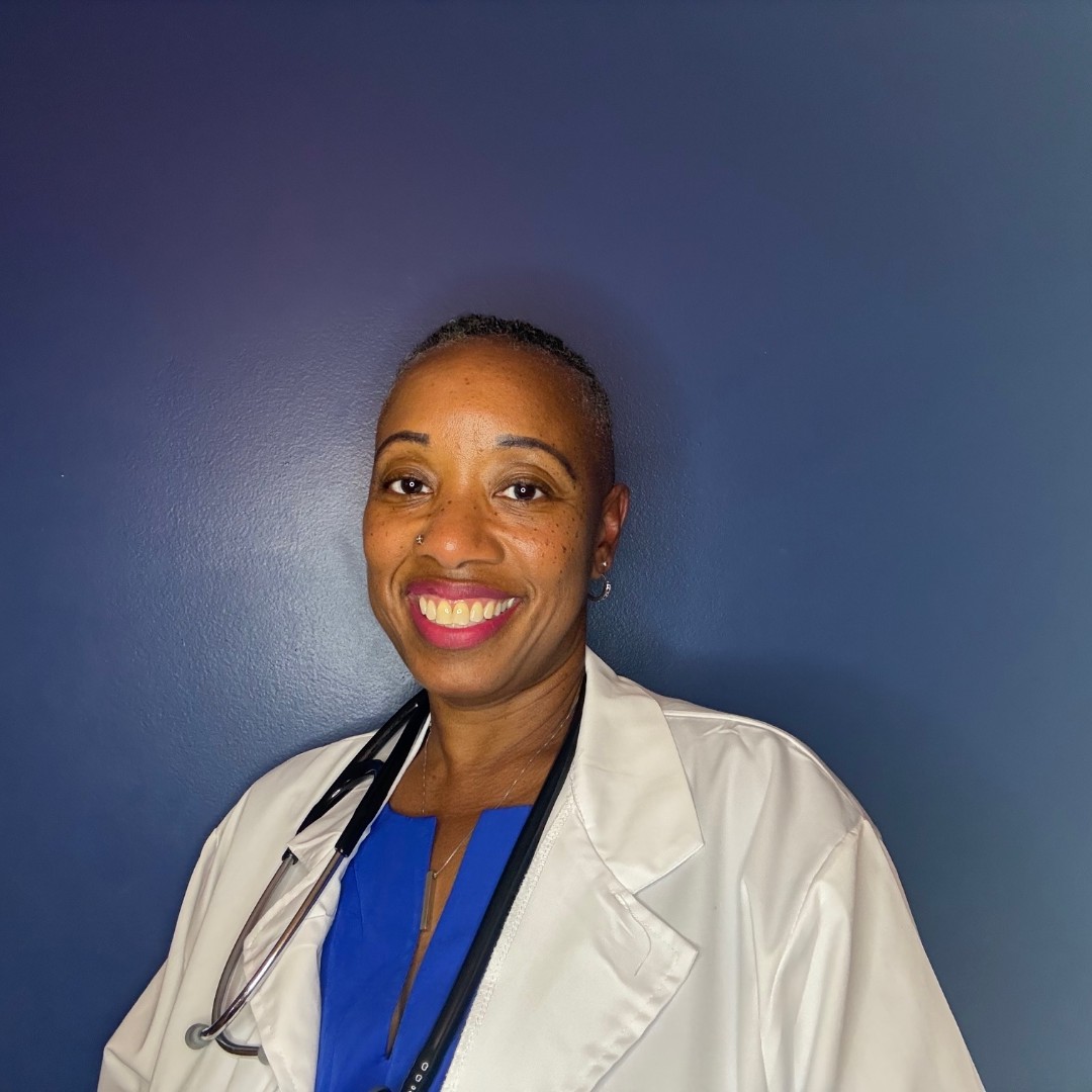 Nicole Griffin, DNP, NP-C, in a white coat with a stethoscope